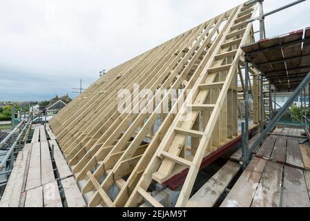 A residential house gets the roof converted to double the size of the house giving the owners more space. Stock Photo