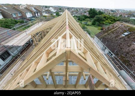 A residential house gets the roof converted to double the size of the house giving the owners more space. Stock Photo