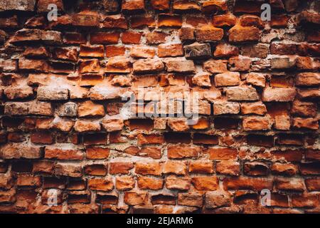 Old damaged wall made from red bricks. Background. Vintage architecture. Stock Photo