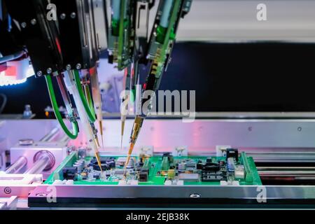 Quality testing of printed circuit boards - flying probe test at factory Stock Photo