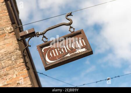 A old sign for a tobacconists shop on a wall in Bologna Italy Stock Photo