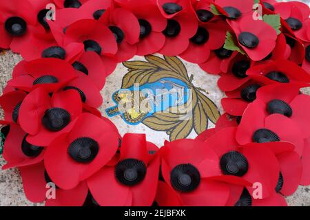 LEYTONSTONE, LONDON - 22ND FEBRUARY 2021: Poppy wreaths on the Leyton and Leytonstone war memorial. Stock Photo