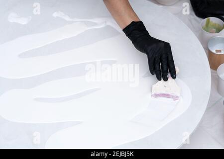 Artistic background. Round canvas with dripping paint. The process of creating a painting using fluid art technique. Stock Photo