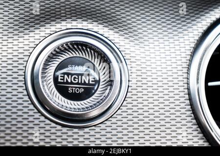Car dashboard with focus on engine start stop button. Modern car interior details. start/stop button. Car inside. Ignition remote starter Stock Photo