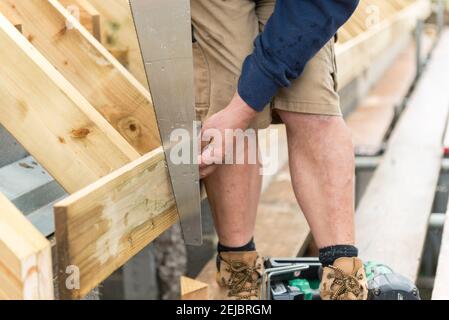 Workmen building a room in the roof on a residential property which used to be a bungalow. Stock Photo