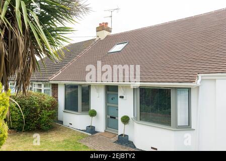 The frontage of a modern single story bungalow home with new double glazed windows Stock Photo