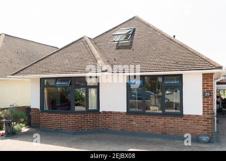 The frontage of a modern single story bungalow home with new double glazed windows Stock Photo
