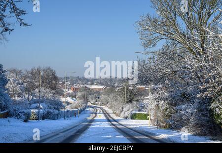 Snow covered road on a winter's day in Market Harborough, Leicestershire, United Kingdom. Stock Photo