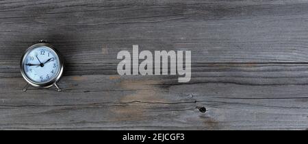 Antique traditional clock on weathered wooden planks in flat lay format Stock Photo