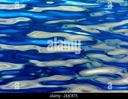 Reflections on shimmering blue water in a tranquil natural setting during daylight hourse Stock Photo