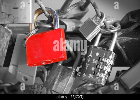 Red Lock of couples in love on the bridge railing in Paris Stock Photo