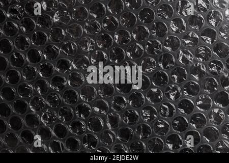 dark air bubble wrap - real life close-up flat texture and background Stock Photo