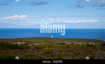 Cape Point- Cape Town, South Africa - 19-02-2021 White statue standing on a ledge overlooking the ocean. Stock Photo