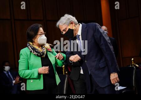 Washington, DC, USA. 22nd Feb, 2021. (L-R) United States Senator Mazie Hirono (Democrat of Hawaii) gives an arm bump to Attorney General nominee Merrick Garland as they arrive for Garland's confirmation hearing before the Senate Judiciary Committee in the Hart Senate Office Building on February 22, 2021 in Washington, DC. Garland previously served at the Chief Judge for the U.S. Court of Appeals for the District of Columbia Circuit. Credit: Drew Angerer/Pool Via Cnp/Media Punch/Alamy Live News Stock Photo