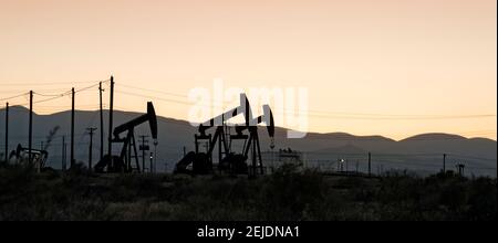 Silhouette of oil rigs at sunset, California, USA Stock Photo