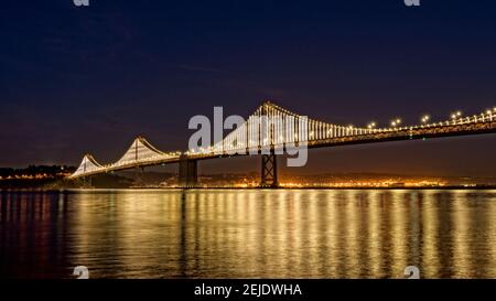 Suspension bridge over Pacific ocean lit up at night, Bay Bridge, San Francisco Bay, San Francisco, California, USA Stock Photo