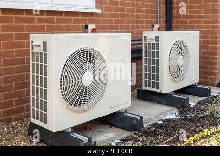 Two air source heat pumps installed on the exterior of a modern house Stock Photo