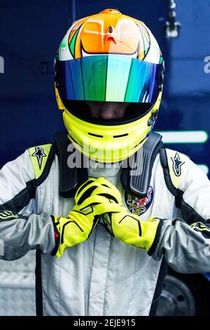 young male car racer with a helmet. racing driver wearing crash helmet Stock Photo