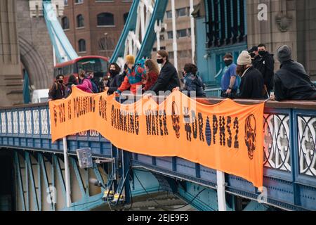 London, UK. 22nd Feb, 2021. Anti HS2 protestors hang a banner from Tower Bridge calling on the government to stop the HS2 project. Credit: Denise Laura Baker/Alamy Live News Stock Photo