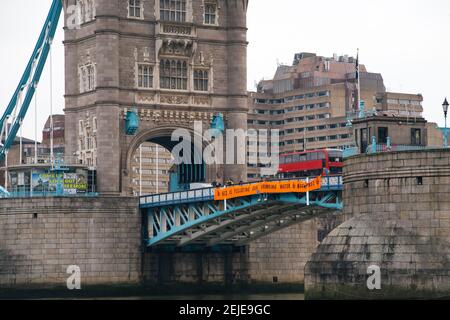 London, UK. 22nd Feb, 2021. Anti HS2 protestors hang a banner from Tower Bridge calling on the government to stop the HS2 project. Credit: Denise Laura Baker/Alamy Live News Stock Photo