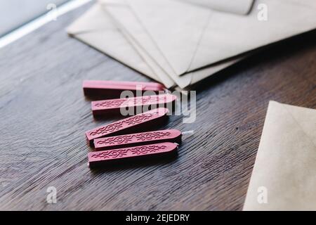 Man makes the stamp using sealing wax on the envelope Stock Photo