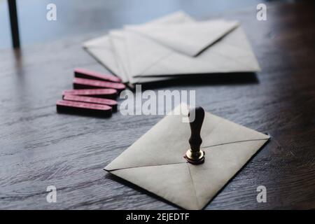 Man makes the stamp using sealing wax on the envelope Stock Photo