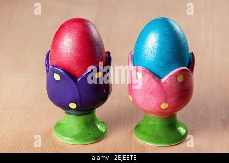 Colored easter eggs in egg cups Stock Photo