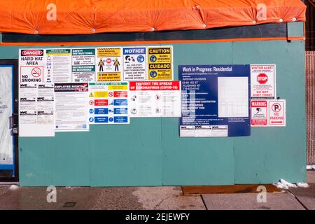 BUREAUCRACY. A construction site on 162nd Street in Flushing, Queens, New York with 19 signs, notices, permits  and warnings Stock Photo