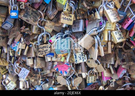 Paris, France Sept 27 2015: Colorful Love locks collection with messages closeup hanging on the Pont des Arts (Arts Bridge) Stock Photo