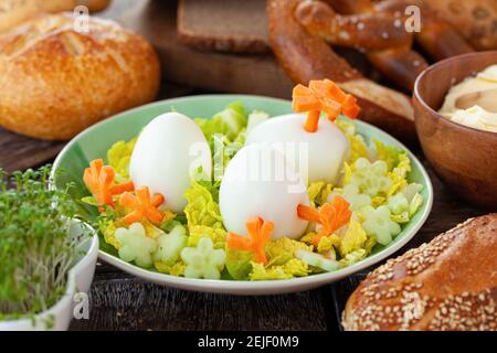 Easter breakfast with hard boiled eggs and bread rolls Stock Photo