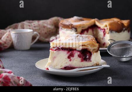 Karpatka with cherries, traditional Polish cream pie on dark background. Stock Photo