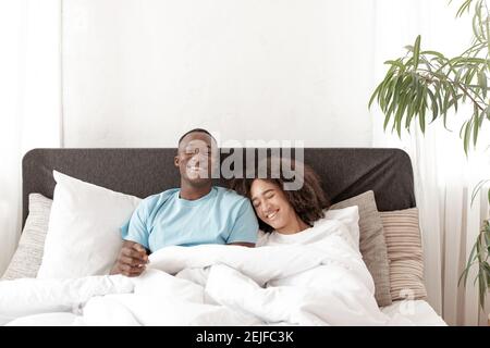 Lovely couple have fun, rest and relax on bed in bedroom, happy together lifestyle Stock Photo