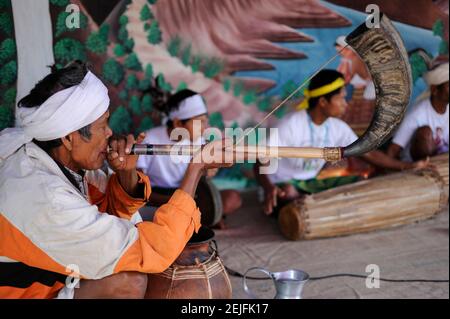 BANGLADESH, Region Madhupur, Garo people are Christians, living in matrilineal society, Wangal festival, men perform traditional music, playing sound with buffalo horn flute Stock Photo