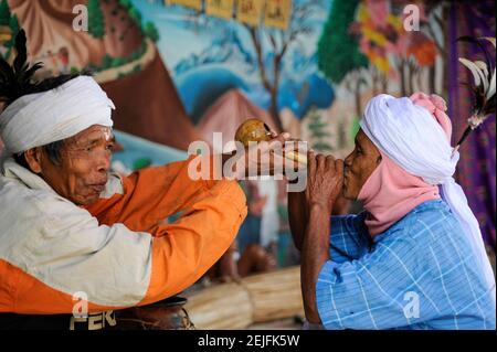 BANGLADESH, Region Madhupur, Garo people are Christians, living in matrilineal society, Wangal festival, men drinking toddy, kind of local palm tree beer Stock Photo