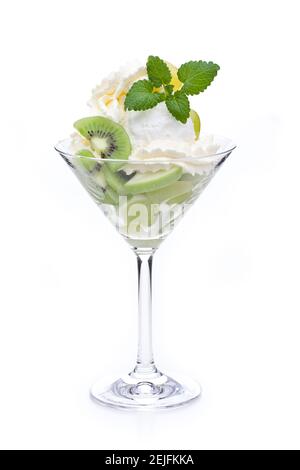 A cup of lemon ice cream decorated with kiwis and mint leaves Stock Photo