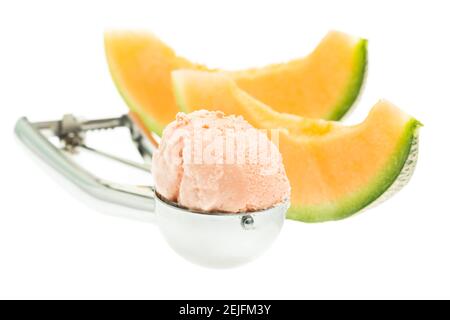 Melon ice cream scoop with melon isolated on white background with spoon Stock Photo