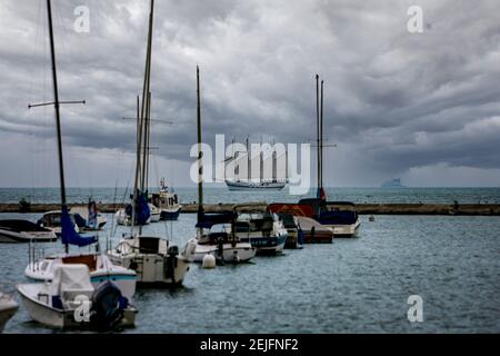 Schooner passes by a yacht basin on the Chicago lakeside. Stock Photo