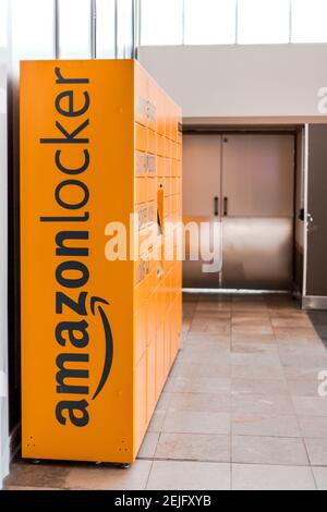 Amazon Locker in shopping mall, orange pick up point for mail order goods with Amazon brand logo on it. Lyon, France - February 23, 2020 Stock Photo