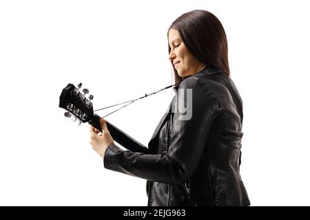 Side shot of a young female with an acoustic guitar isolated on white background Stock Photo