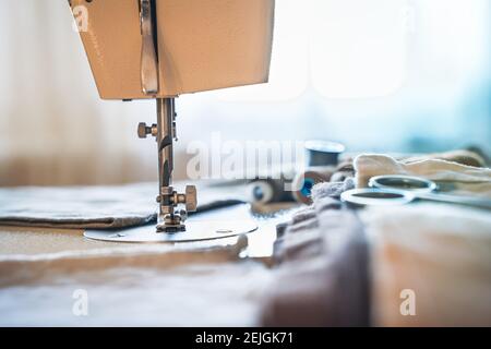 Sewing machine on a light background. Side view with copy space. The concept of sewing. Stock Photo