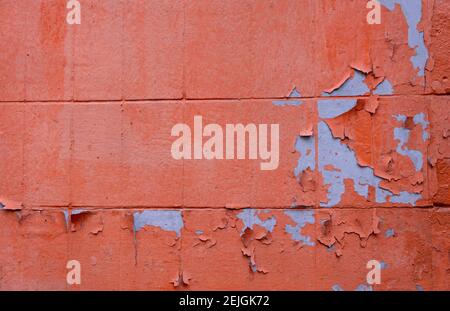 Grunge Concrete Wall Texture peeling paint, old cracked wall peach or pink colored closeup Stock Photo