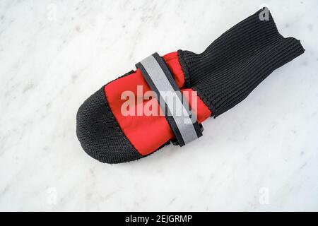 Dog boots on a white marble background. Stock Photo