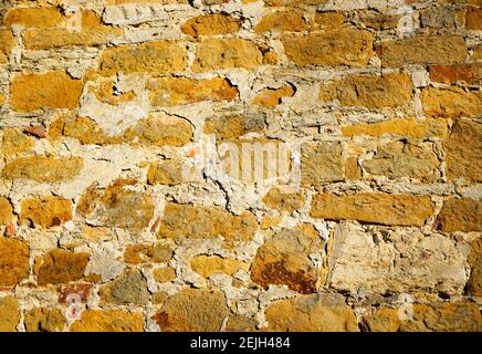 Wall of an old monastery. Stone wall made of rubble stones as a background. Stock Photo