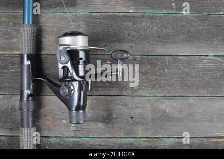 flat lay with fishing tackle, fishing rod and plastic box with fishing  tackle and hooks, feeders on wooden planks, copy space Stock Photo - Alamy