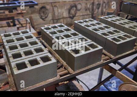 Cinder blocks lie on the ground and dried. on cinder block production plant Stock Photo
