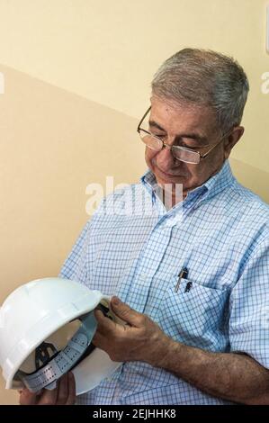 Civil engineer putting his helmet on Stock Photo