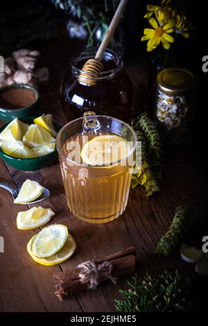 Dried mountain tea, turmeric, cinnamon sticks, lemon slices and jar of honey on wooden background.  Sideritis Scardica. Stock Photo