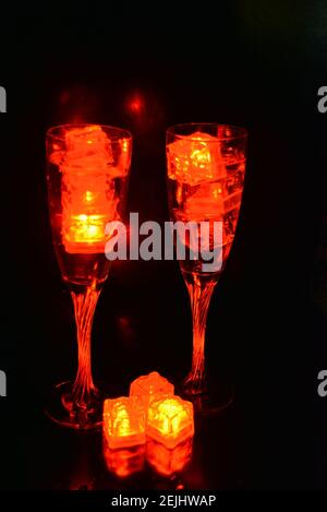 Led blue, white ice floes are floating in a stainless steel dipper with an interesting metal reflection. Stock Photo