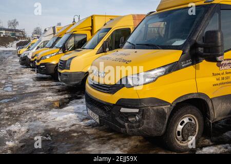 Tczew, Poland - February 21, 2021: A line of yellow trucks at the parking Stock Photo