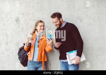 Students on campus taking a selfie with a phone Stock Photo